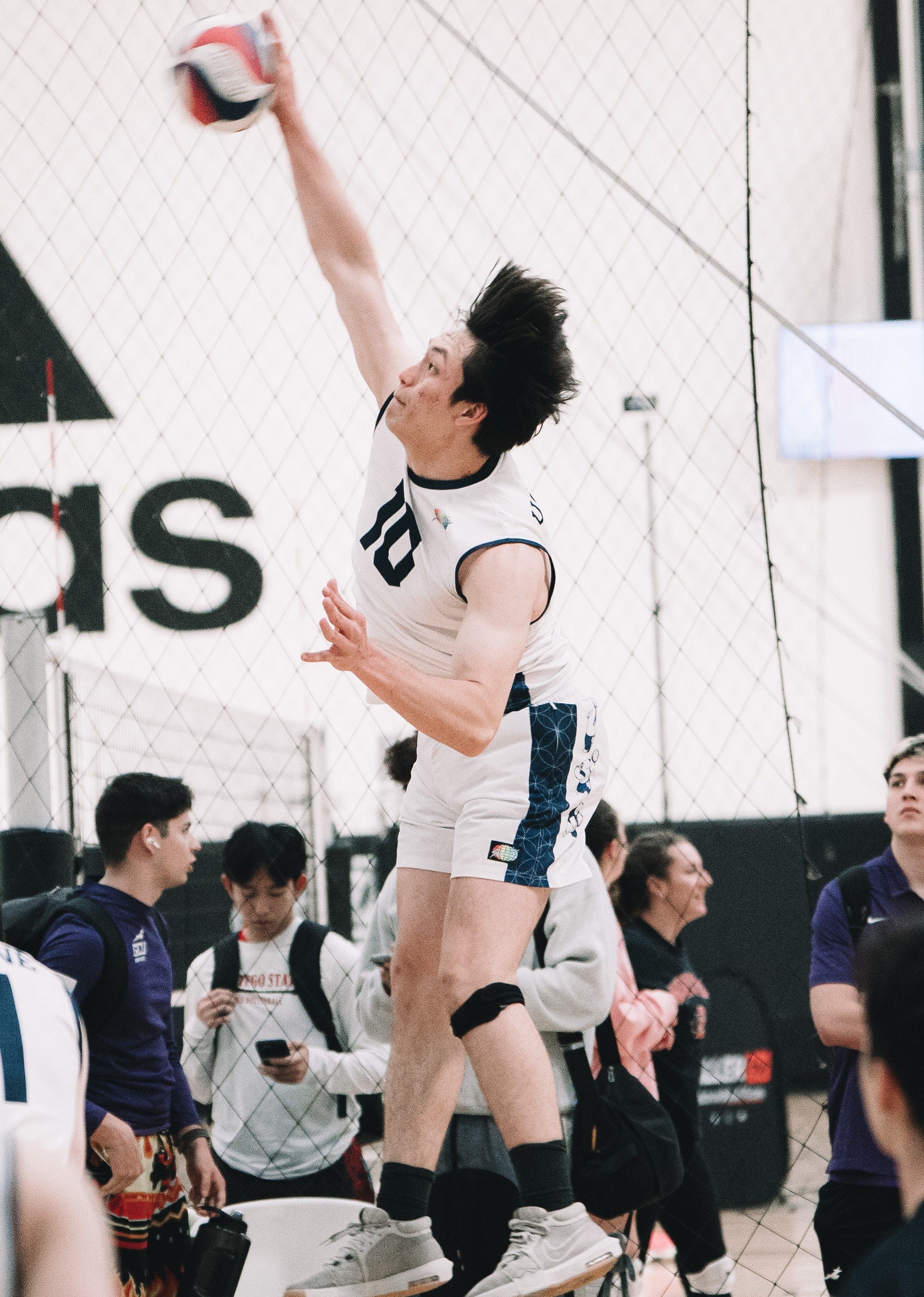 Man in white shorts hitting ball